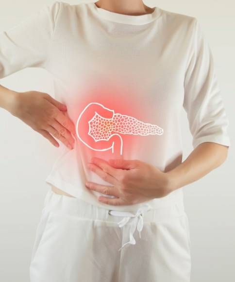 A person experiencing abdominal pain related to pancreatitis and pancreas.